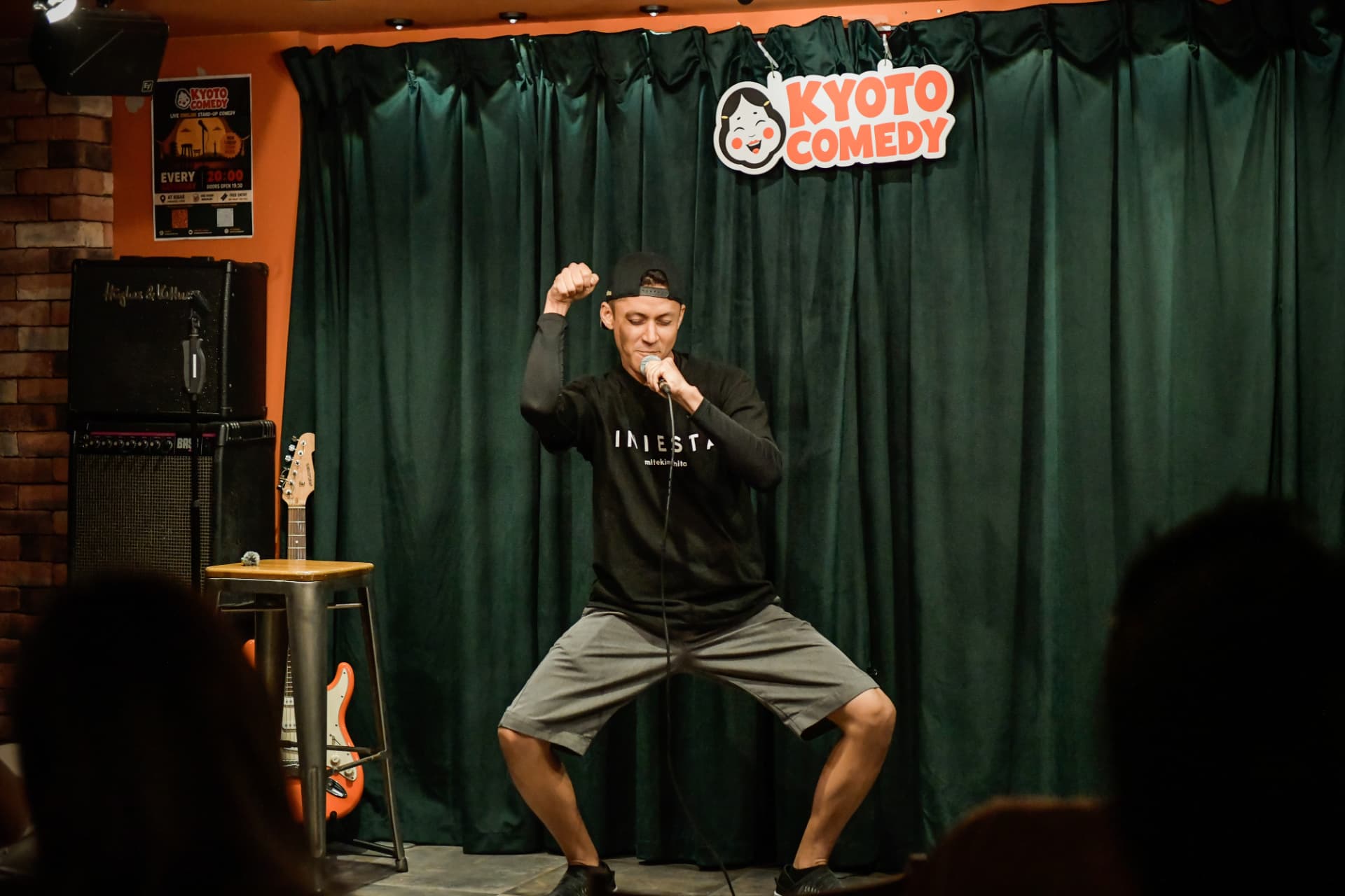 Comedian performing an energetic set at Kyoto Comedy