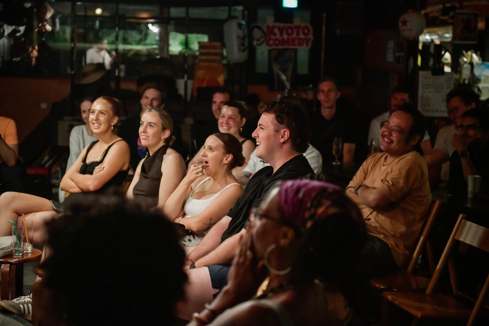 International audience laughing together during a Kyoto Comedy show