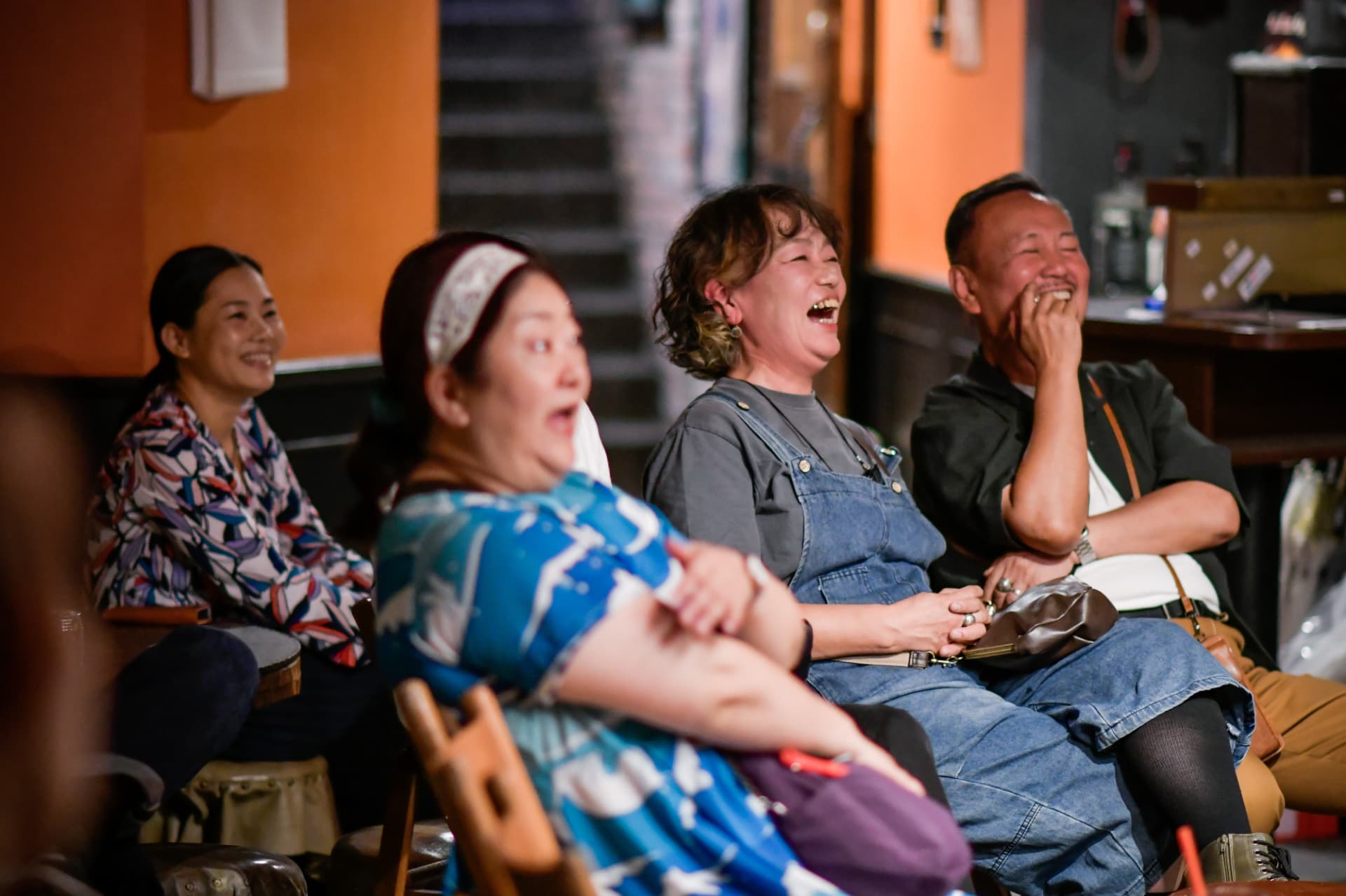 Audience laughing together during a live stand-up comedy show in Kyoto