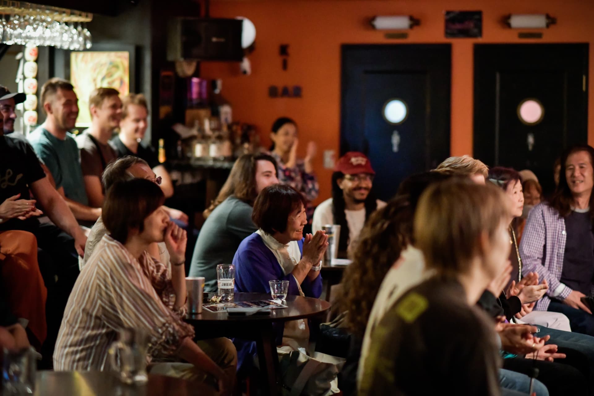 Audience applauding during a live Kyoto Comedy show at Ki Bar